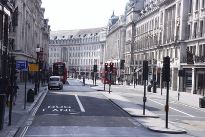 Vehicles on road along buildings