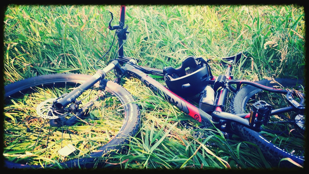 transportation, mode of transport, land vehicle, bicycle, transfer print, auto post production filter, stationary, grass, parked, plant, parking, car, growth, day, metal, high angle view, outdoors, no people, green color, wheel