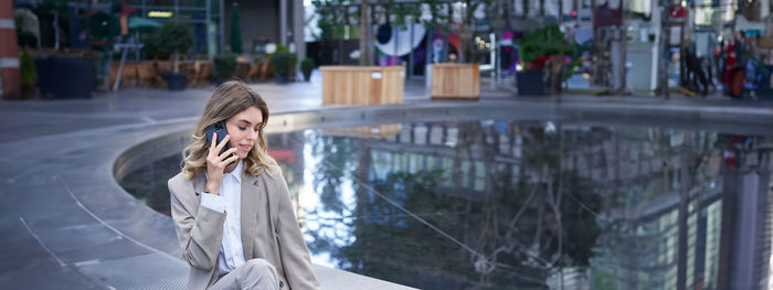 Portrait of woman standing in city