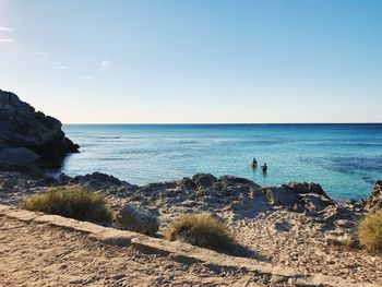 Scenic view of sea against clear blue sky