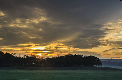 Scenic view of field against sky during sunset