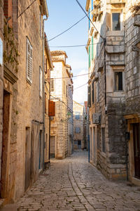 Narrow alley amidst buildings in town