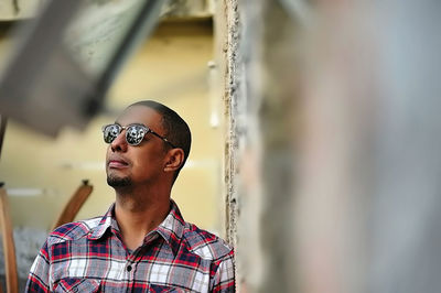 Thoughtful man leaning on wall