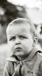 Little boy in hoodie playing outside