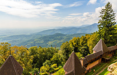 Panoramic view of trees and houses against sky