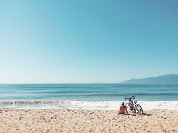 Scenic view of beach against clear blue sky