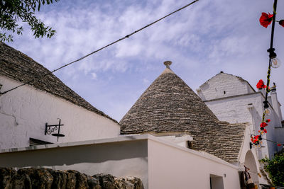 Low angle view of trulli buildings against sky