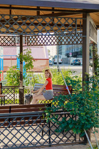 Full length of woman standing by plants