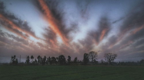 Panoramic view of field against sky during sunset