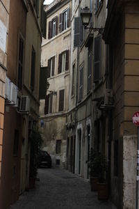 Narrow street amidst buildings in city