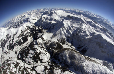 Scenic view of snowcapped mountains against clear sky