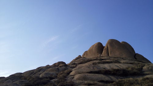 Low angle view of rock formation against clear sky