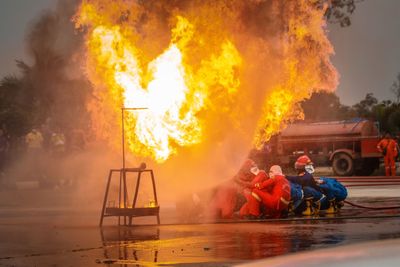 Firefighters spaying water on fire