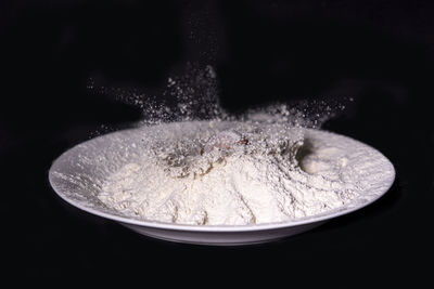 Close-up of ice cream over black background