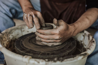 Close-up of artist making pot at workshop