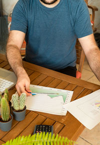 High angle view of man sitting on table