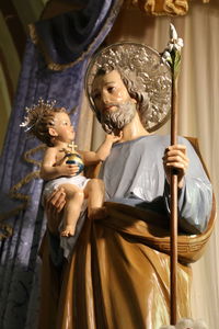 Low angle view of saint joseph with infant jesus statue in church