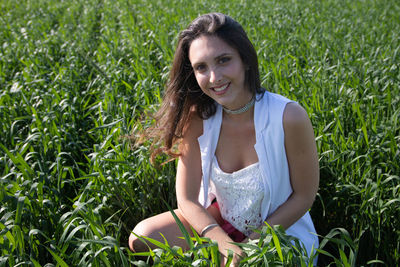 Young woman sitting on field