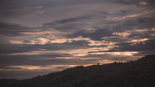 Low angle view of silhouette mountain against dramatic sky