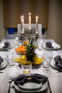 Close-up of illuminated candles on table