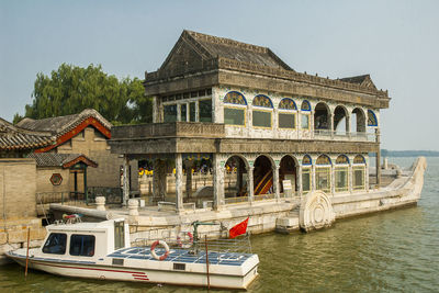 Boats in river against buildings