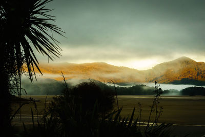 Scenic view of lake against sky during sunset