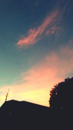 Low angle view of silhouette trees against sky at sunset