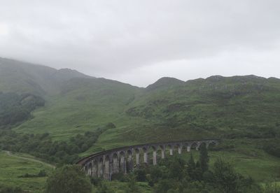 Scenic view of mountains against cloudy sky