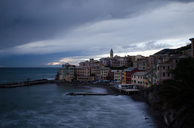 View of city by sea against sky