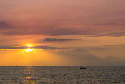 Scenic view of sea against orange sky