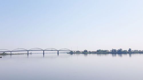 Bridge over river against clear sky