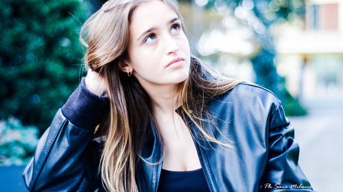 Portrait of young woman wearing hat