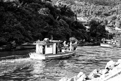 High angle view of people on boat in river by trees