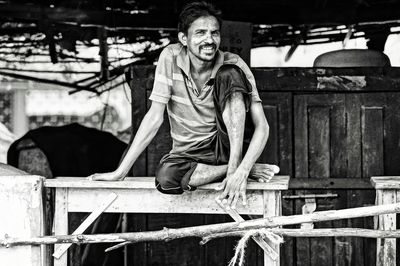 Portrait of man sitting on table