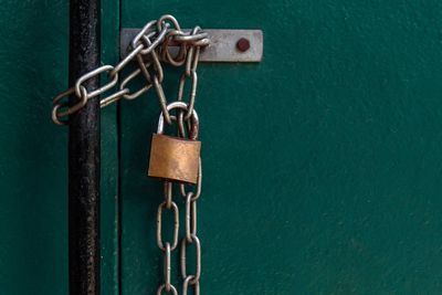 Close-up of padlocks hanging on rusty metal