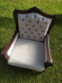 High angle view of empty chair on field