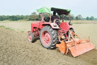 Tractor on field against sky