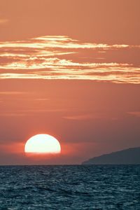 Scenic view of sea against romantic sky at sunset