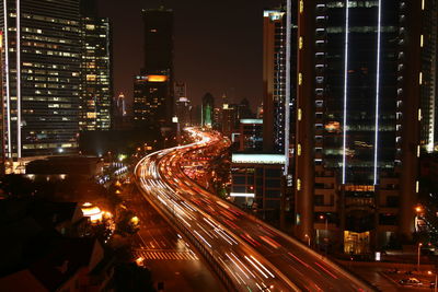 Light trails on road in city at night