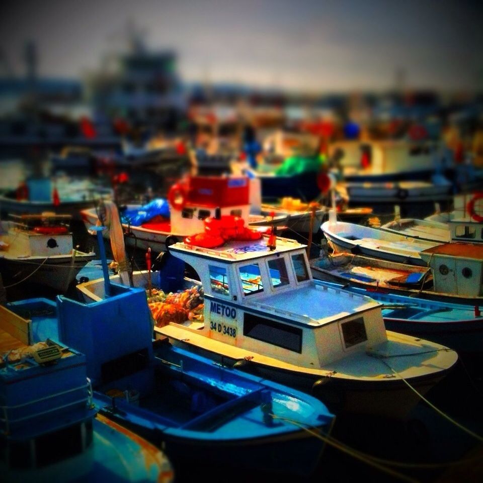 architecture, building exterior, built structure, focus on foreground, city, selective focus, indoors, high angle view, nautical vessel, cityscape, no people, multi colored, large group of objects, table, crowded, moored, boat, close-up, day, water