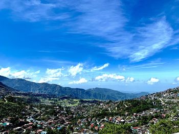 Scenic view of mountains against blue sky