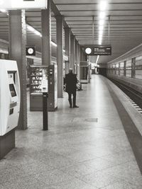 Rear view of man walking in corridor