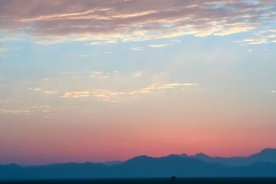 Scenic view of silhouette mountains against sky during sunset