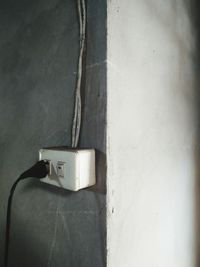 Close-up of electric lamp against wall