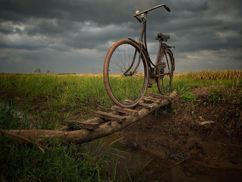 Bicycle on field against sky