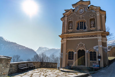 Church by building against sky