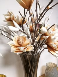 Close-up of white roses in vase on table