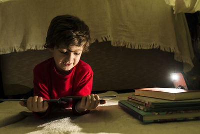 Boy reading book at home