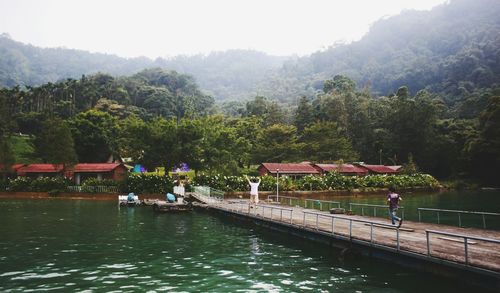 Scenic view of river with mountains in background