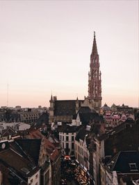 High angle view of illuminated buildings in town against clear sky before sunset